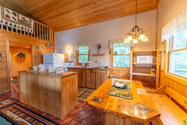 kitchen featuring white appliances, wood walls, wood ceiling, and parquet floors