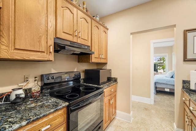 kitchen featuring baseboards, black range with electric cooktop, dark stone counters, and under cabinet range hood