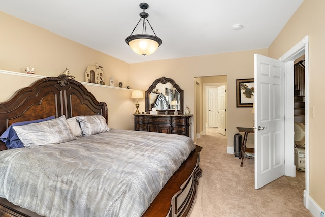 bedroom with light carpet and baseboards