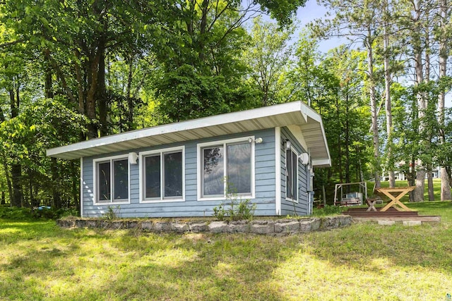 view of home's exterior with a lawn and a wooden deck