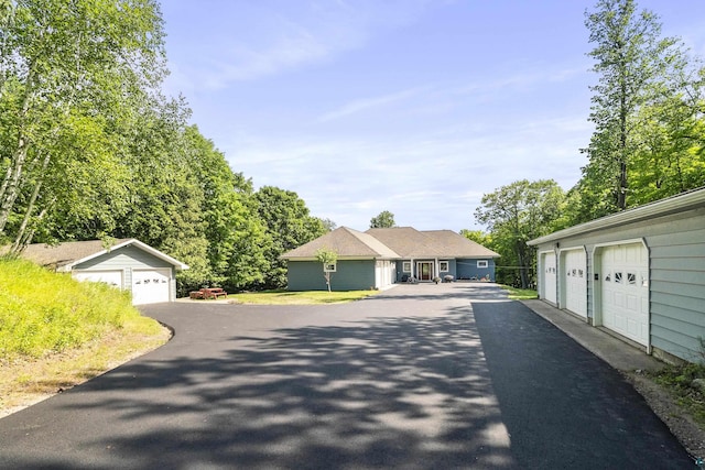 view of front of home with an outdoor structure and community garages