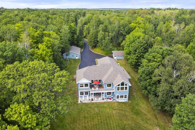 birds eye view of property with a view of trees