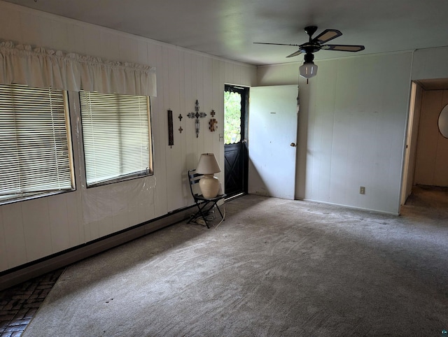 spare room with ceiling fan and light carpet