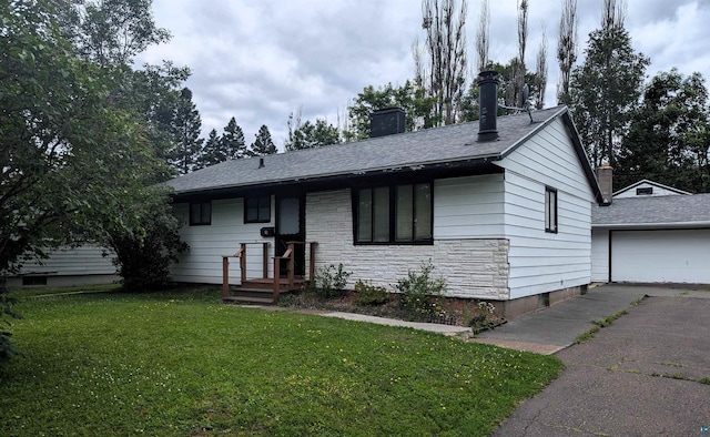 ranch-style home with a garage and a front lawn