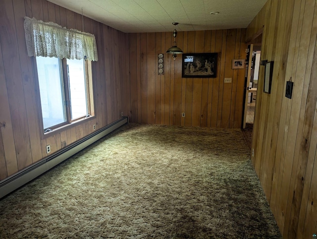 unfurnished room featuring a baseboard heating unit, carpet floors, and wooden walls