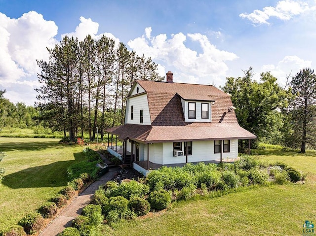 country-style home with a porch, cooling unit, and a front yard