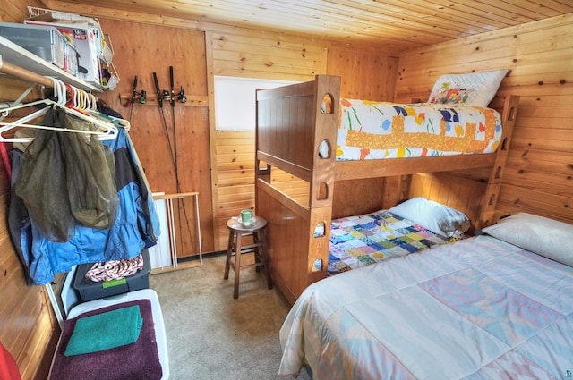 bedroom with wood ceiling, wooden walls, and light colored carpet