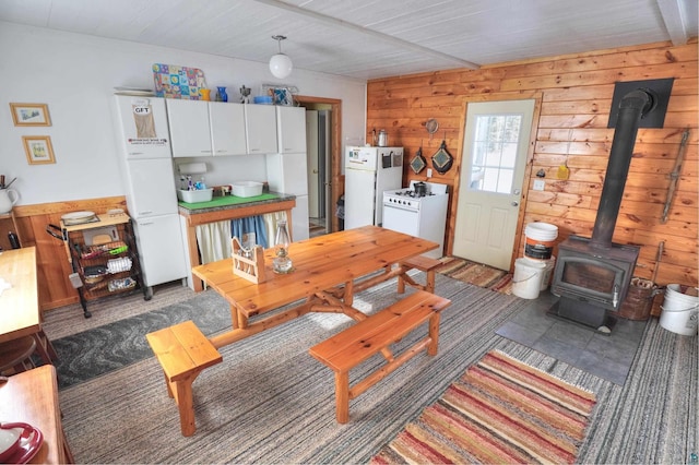 living room with wood walls and a wood stove