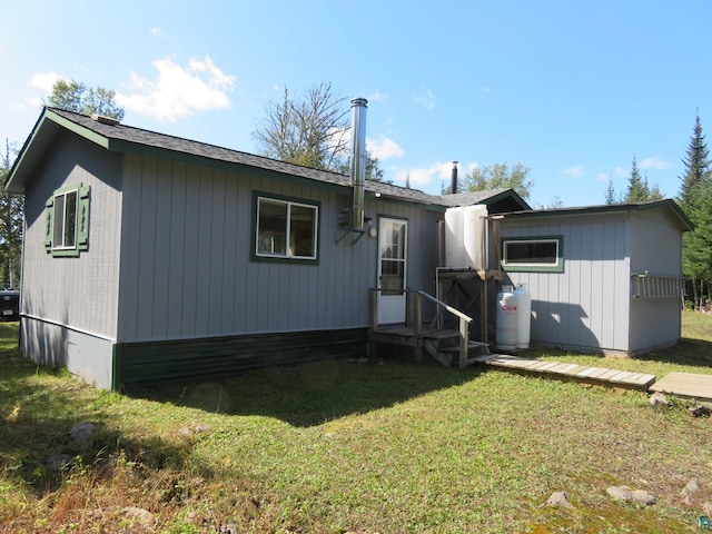 rear view of house with a yard