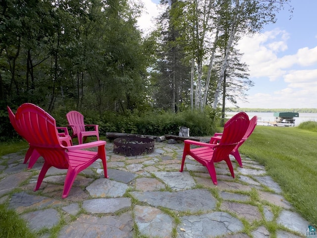 view of patio featuring a fire pit and a water view