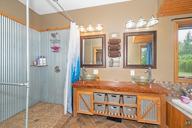 bathroom with plenty of natural light and dual bowl vanity