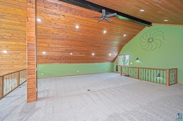 empty room with beam ceiling, light colored carpet, wooden ceiling, and ceiling fan