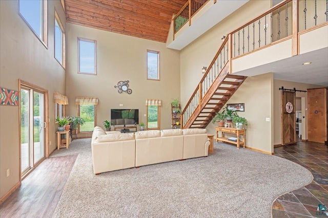 living room with wood ceiling, high vaulted ceiling, wood-type flooring, and a barn door