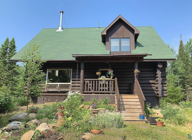 log home featuring covered porch