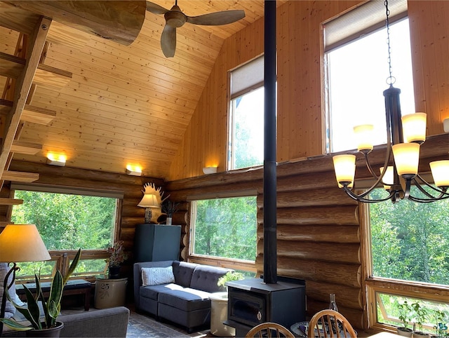 living room featuring log walls, a wealth of natural light, high vaulted ceiling, ceiling fan with notable chandelier, and wood ceiling