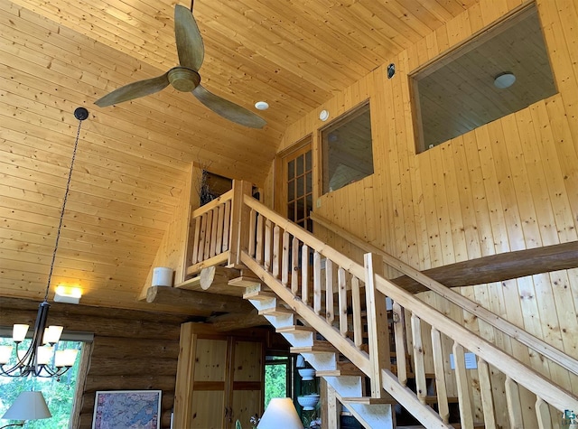 interior space with high vaulted ceiling, a notable chandelier, rustic walls, and wood ceiling