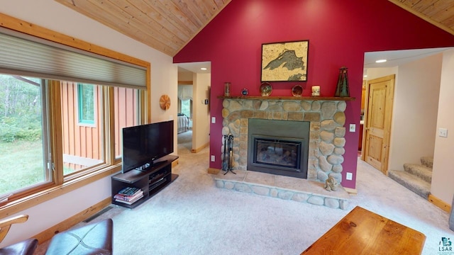 living room featuring carpet floors, wood ceiling, a stone fireplace, and plenty of natural light