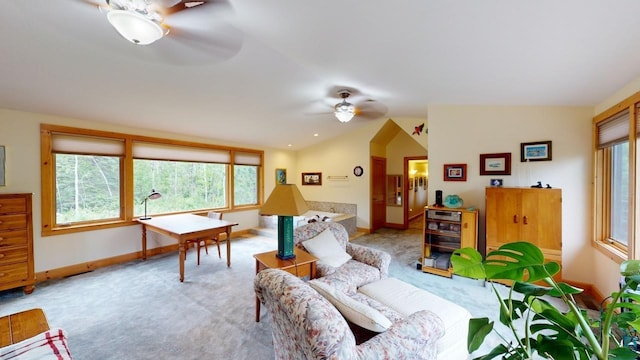 interior space featuring ceiling fan, light colored carpet, and vaulted ceiling