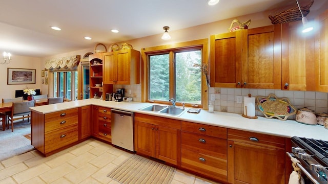 kitchen featuring appliances with stainless steel finishes, sink, backsplash, a chandelier, and kitchen peninsula