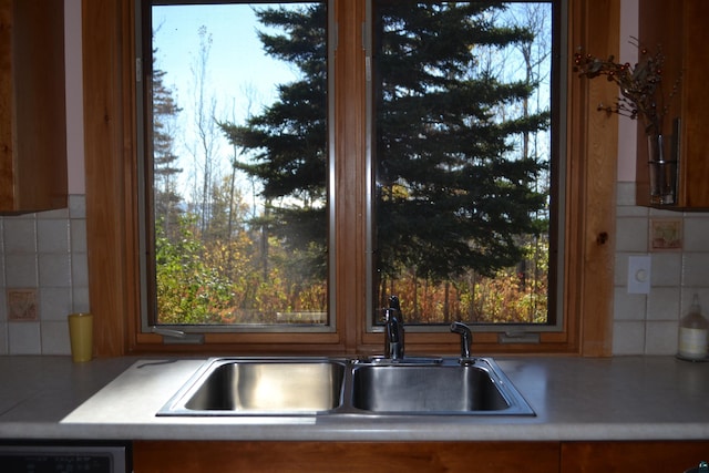 kitchen featuring a healthy amount of sunlight, sink, and decorative backsplash