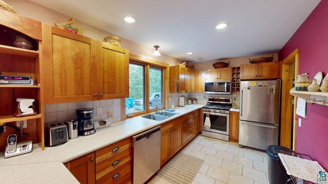 kitchen featuring tasteful backsplash, appliances with stainless steel finishes, and sink