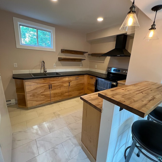 kitchen with wood counters, sink, stainless steel range with electric cooktop, decorative light fixtures, and wall chimney exhaust hood