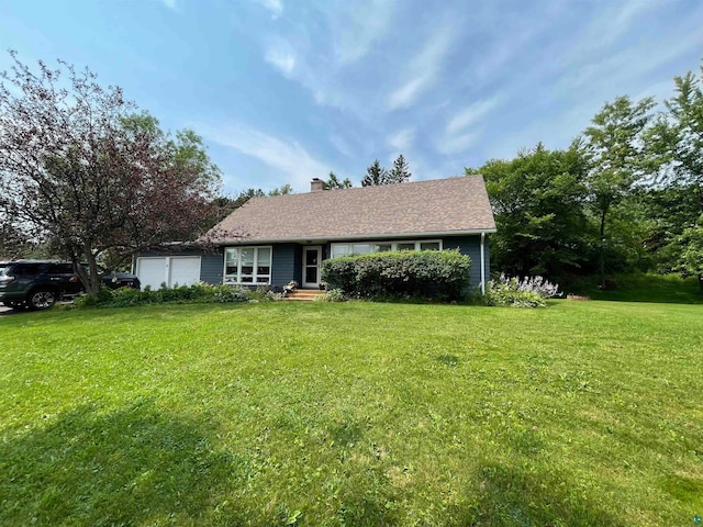 view of front of house with a garage and a front yard