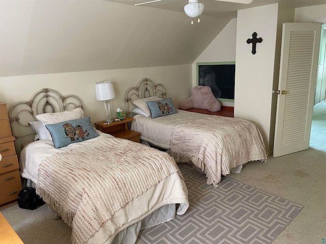 carpeted bedroom featuring lofted ceiling and ceiling fan