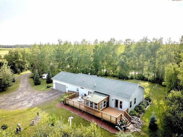 birds eye view of property featuring a view of trees