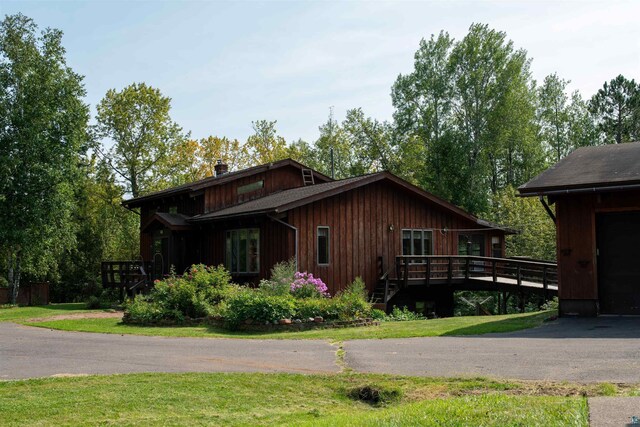 rear view of property with a lawn