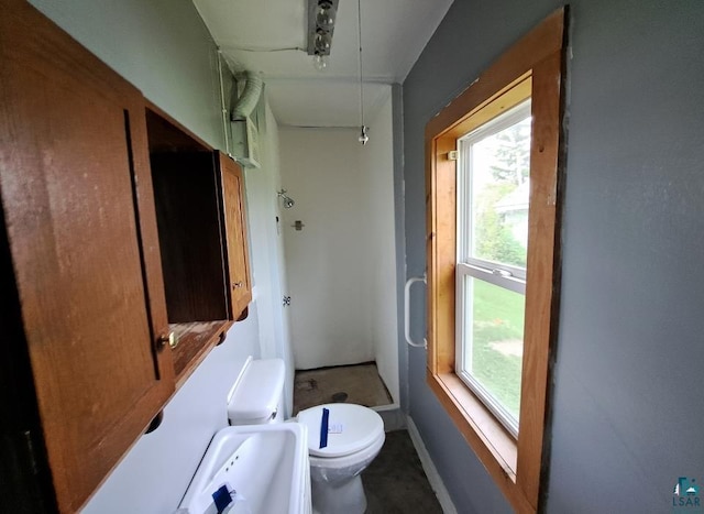 bathroom featuring a healthy amount of sunlight and toilet