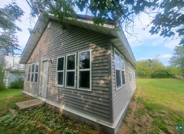 view of home's exterior with a lawn