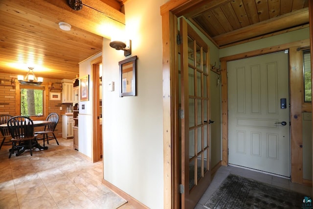 entrance foyer with wooden ceiling, a notable chandelier, and light tile patterned flooring