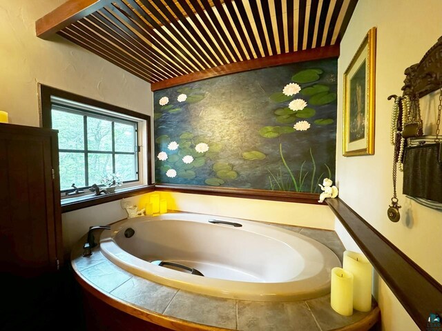 bathroom with a tub and wooden ceiling