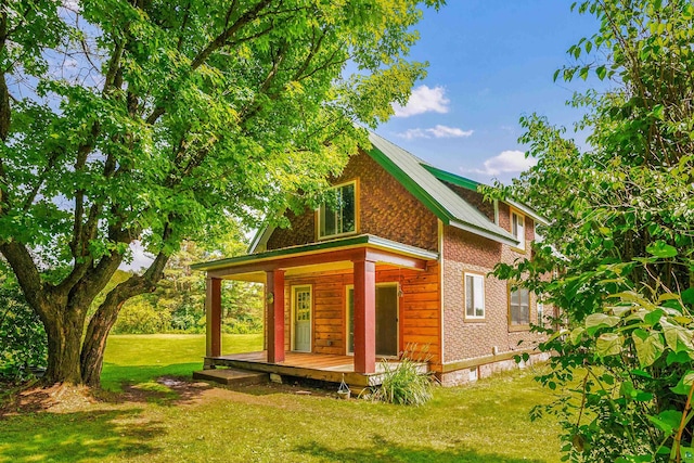 rear view of property with a yard