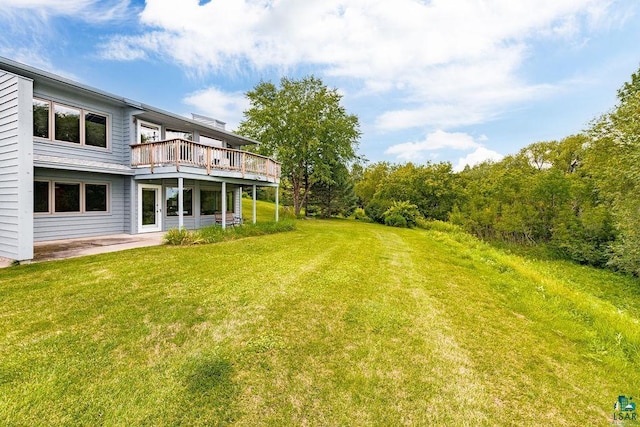 view of yard with a deck and a patio