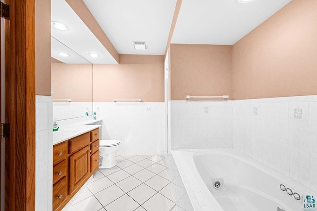 bathroom with visible vents, toilet, vanity, tile patterned flooring, and a whirlpool tub