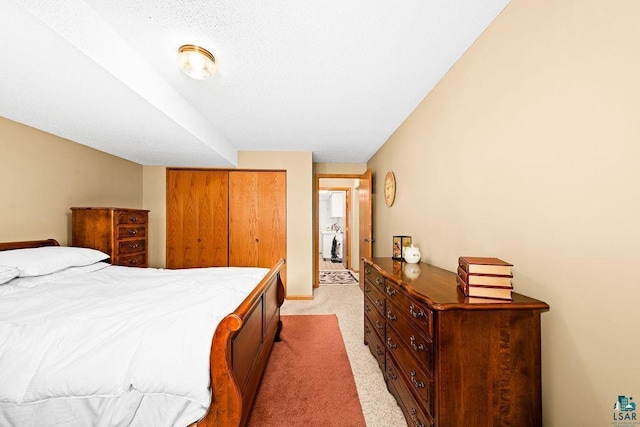 bedroom with a closet and light carpet