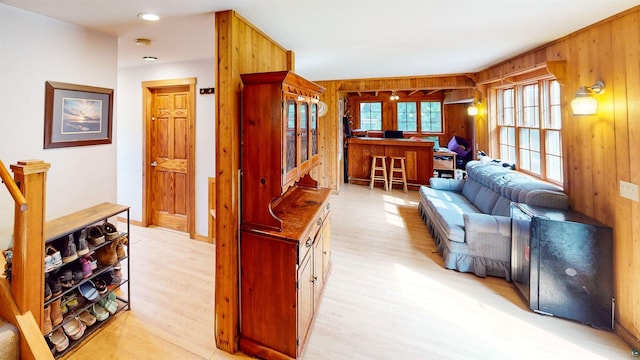 living room featuring wood walls and light hardwood / wood-style floors