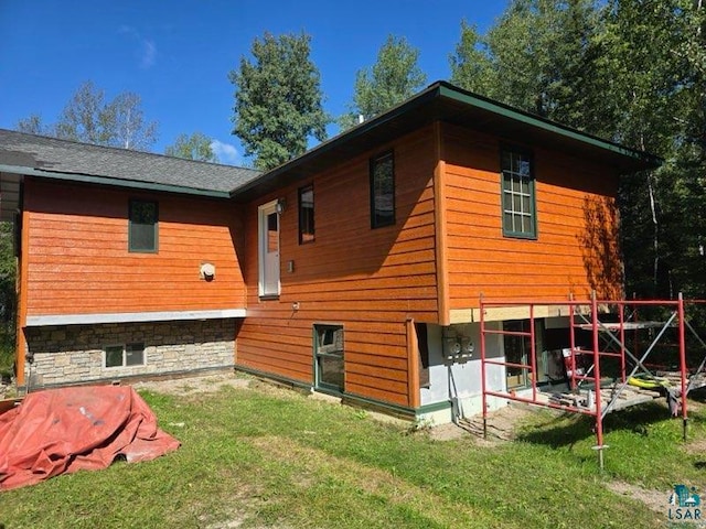 back of property featuring a patio area and a yard