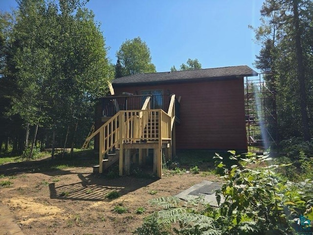 view of play area featuring stairs and a deck