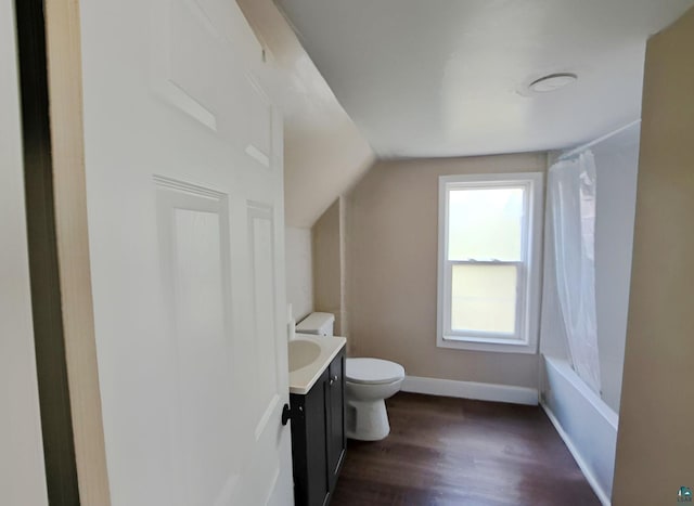 full bathroom with vanity, vaulted ceiling, shower / tub combo, toilet, and hardwood / wood-style flooring