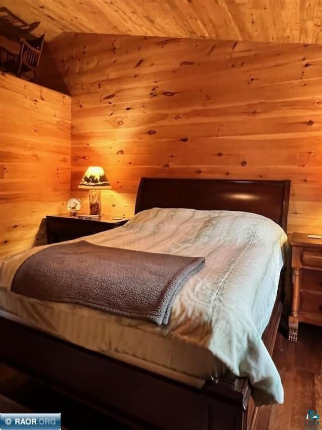 bedroom featuring vaulted ceiling, wood walls, wood finished floors, and wood ceiling