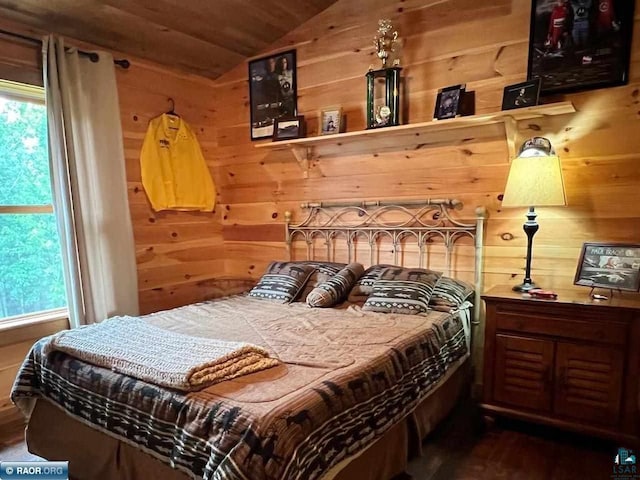 bedroom with wood ceiling, vaulted ceiling, multiple windows, and wood walls