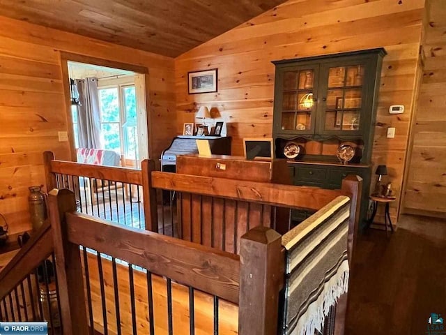 interior space featuring wood ceiling, vaulted ceiling, wood walls, and wood finished floors