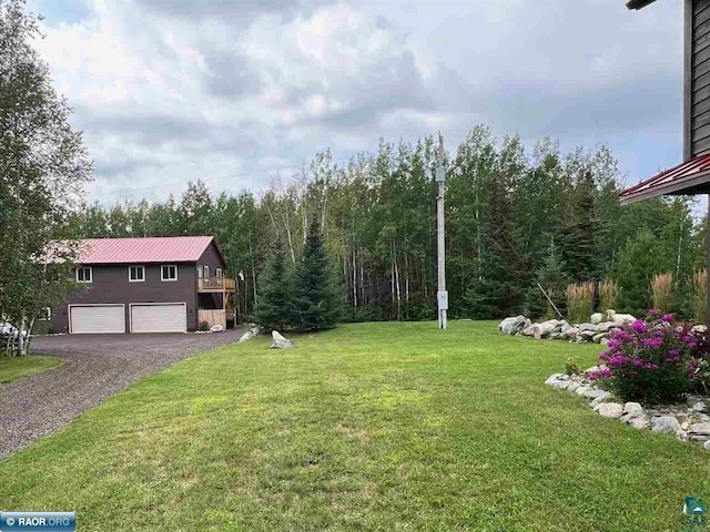 view of yard featuring driveway and an attached garage