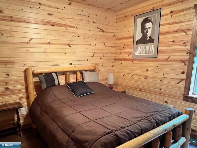 bedroom featuring wooden walls