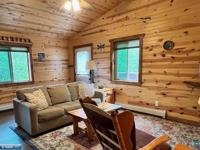 living room with wooden ceiling, wooden walls, a baseboard heating unit, wood finished floors, and vaulted ceiling