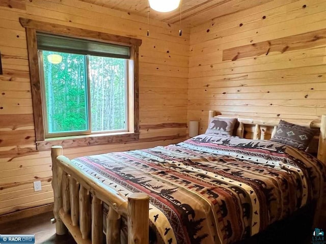 bedroom with wood walls