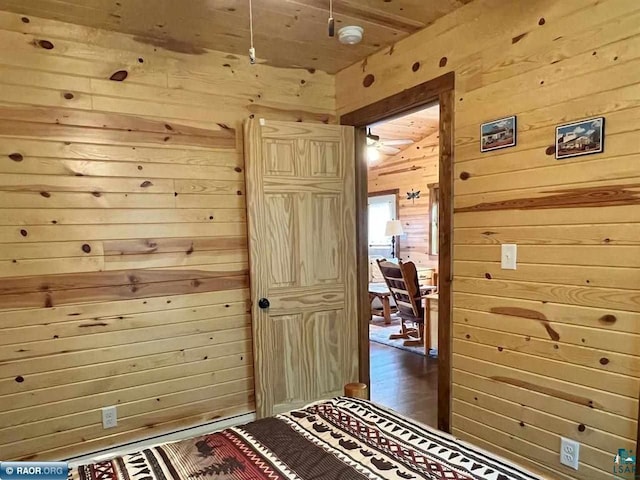 bedroom featuring wood walls and wood finished floors